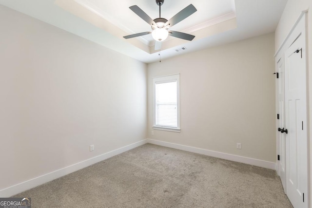 115 Gracetree Way, Kathleen, GA 31047 - spare room with a tray ceiling, light colored carpet, and a ceiling fan