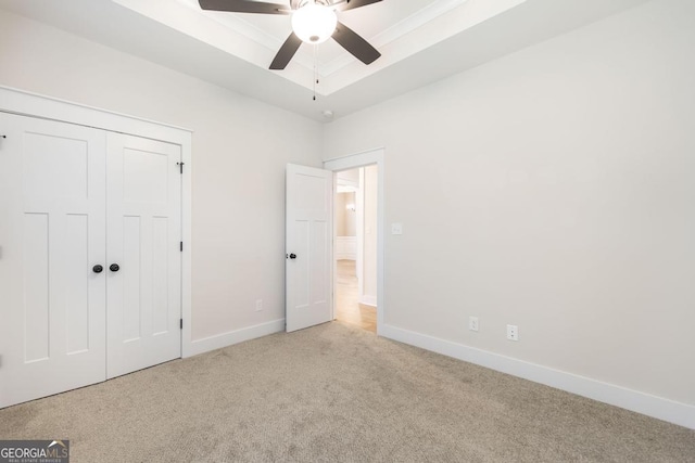115 Gracetree Way, Kathleen, GA 31047 - unfurnished bedroom with carpet, a tray ceiling, a closet, and ceiling fan