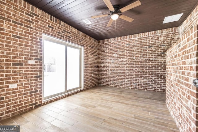 115 Gracetree Way, Kathleen, GA 31047 - empty room featuring wooden ceiling, brick wall, a ceiling fan, and wood finished floors