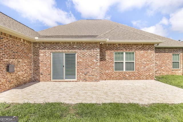 115 Gracetree Way, Kathleen, GA 31047 - rear view of house featuring brick siding, roof with shingles, and a patio