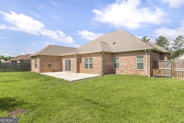 115 Gracetree Way, Kathleen, GA 31047 - rear view of house with a patio, a fenced backyard, a shingled roof, and brick siding