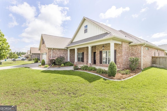 115 Gracetree Way, Kathleen, GA 31047 - view of front facade with board and batten siding, brick siding, covered porch, concrete driveway, and a garage