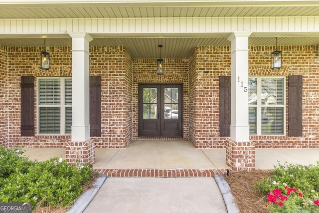 115 Gracetree Way, Kathleen, GA 31047 - doorway to property featuring french doors, brick siding, and covered porch