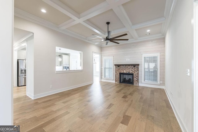 115 Gracetree Way, Kathleen, GA 31047 - unfurnished living room with a ceiling fan, beamed ceiling, a brick fireplace, light wood-type flooring, and coffered ceiling