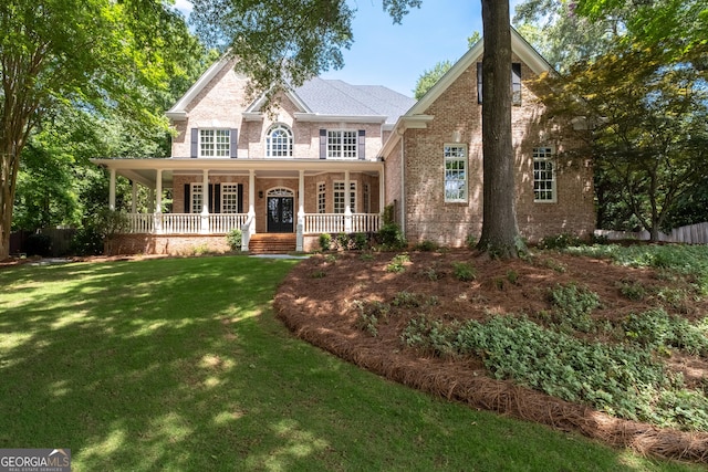 1650 Harvest Ln, Alpharetta, GA 30004 - view of front of house with brick siding, covered porch, and a front yard