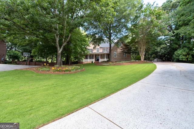 1650 Harvest Ln, Alpharetta, GA 30004 - view of front facade with a front lawn, concrete driveway, and covered porch