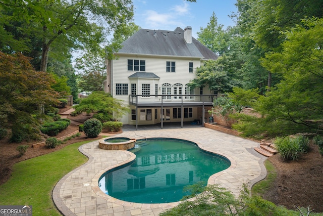 1650 Harvest Ln, Alpharetta, GA 30004 - back of house featuring a patio area, a pool with connected hot tub, a chimney, and a wooden deck