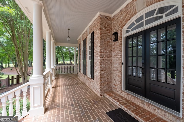 1650 Harvest Ln, Alpharetta, GA 30004 - entrance to property featuring covered porch, french doors, and brick siding