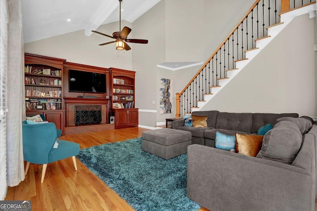 1875 Edgemont Ct, Cumming, GA 30041 - living area featuring wood finished floors, beamed ceiling, ceiling fan, a premium fireplace, and high vaulted ceiling