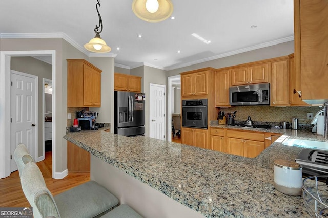 1875 Edgemont Ct, Cumming, GA 30041 - kitchen featuring appliances with stainless steel finishes, tasteful backsplash, light stone counters, light wood-style flooring, and a peninsula