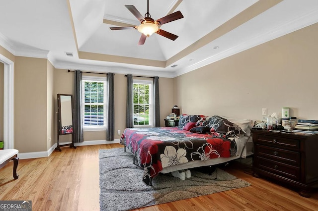 1875 Edgemont Ct, Cumming, GA 30041 - bedroom featuring a raised ceiling, wood finished floors, crown molding, and ceiling fan