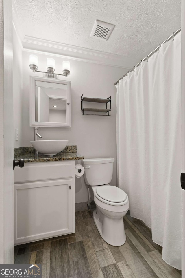 111 Northdale Pl, Lawrenceville, GA 30046 - bathroom featuring vanity, wood finished floors, crown molding, and a textured ceiling