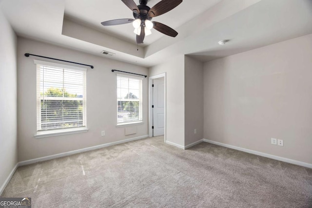 1005 Bayrose Cir Unit 5A, Atlanta, GA 30344 - spare room featuring a tray ceiling, carpet flooring, and ceiling fan