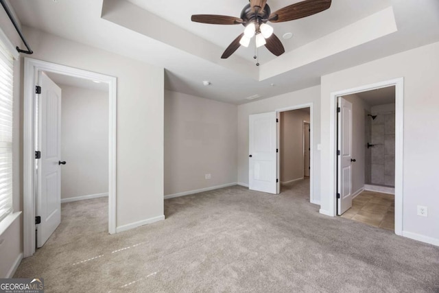 1005 Bayrose Cir Unit 5A, Atlanta, GA 30344 - unfurnished bedroom with light colored carpet, a raised ceiling, a walk in closet, and ensuite bath