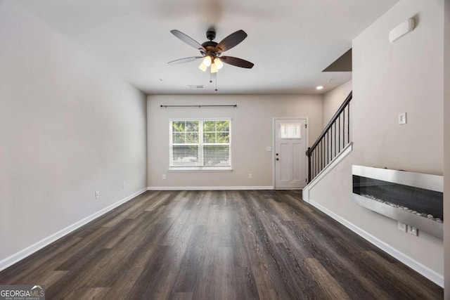 1005 Bayrose Cir Unit 5A, Atlanta, GA 30344 - unfurnished living room featuring dark wood-style floors, ceiling fan, and stairway