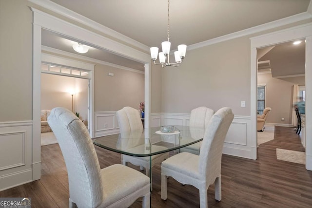 4636 SW Silver Oak Dr SW, Gainesville, GA 30504 - dining space with dark wood-style floors, a chandelier, ornamental molding, wainscoting, and a decorative wall