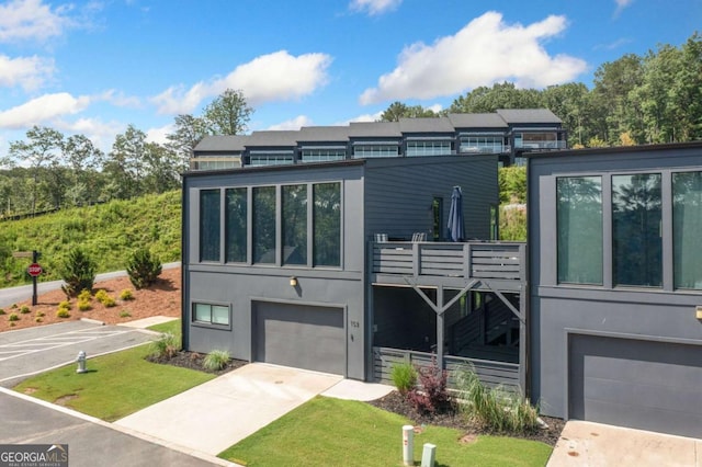 103 Marina Parc Dr, Waleska, GA 30183 - modern home with a garage, concrete driveway, stucco siding, and stairway