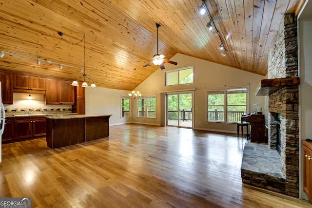 55 Cool Spring Ln, Clayton, GA 30525 - kitchen with track lighting, open floor plan, a stone fireplace, a chandelier, and wood ceiling