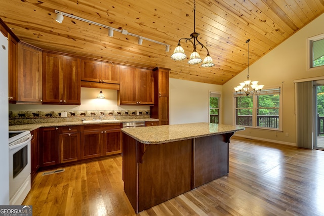 55 Cool Spring Ln, Clayton, GA 30525 - kitchen featuring white range with electric stovetop, a chandelier, track lighting, light wood finished floors, and light stone counters