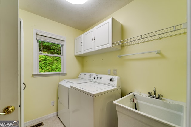 55 Cool Spring Ln, Clayton, GA 30525 - laundry area with cabinet space, washing machine and clothes dryer, and light tile patterned flooring