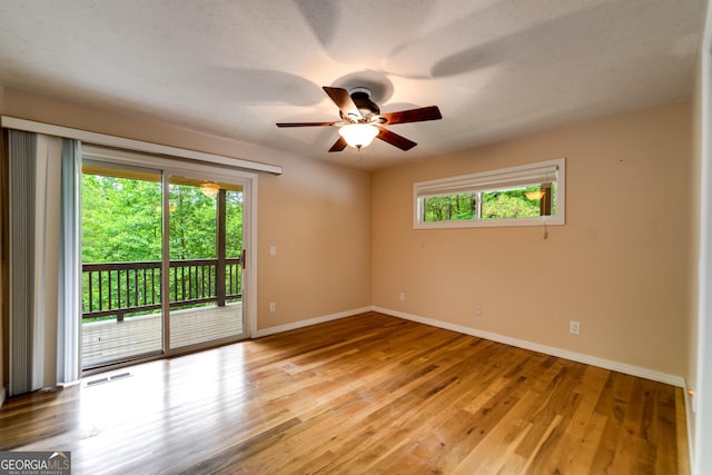 55 Cool Spring Ln, Clayton, GA 30525 - empty room with plenty of natural light, a ceiling fan, and wood finished floors