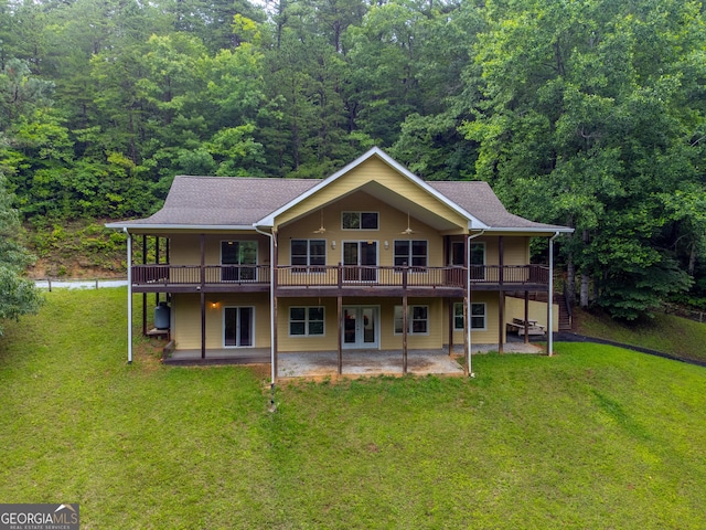 55 Cool Spring Ln, Clayton, GA 30525 - back of property featuring a lawn, a patio, a wooded view, a deck, and roof with shingles