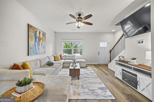 1004 Bayrose Cir, East Point, GA 30344 - living area with wood finished floors, ceiling fan, stairs, and recessed lighting