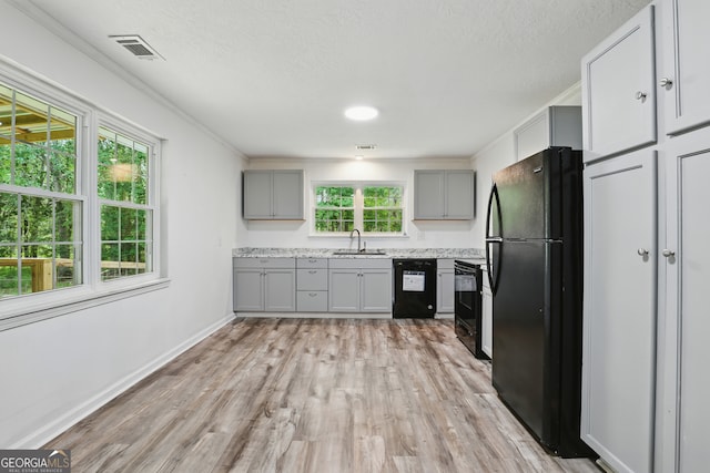 1469 Tabernacle Church Rd, Lincolnton, GA 30817 - kitchen featuring black appliances, gray cabinets, light wood-type flooring, a textured ceiling, and ornamental molding