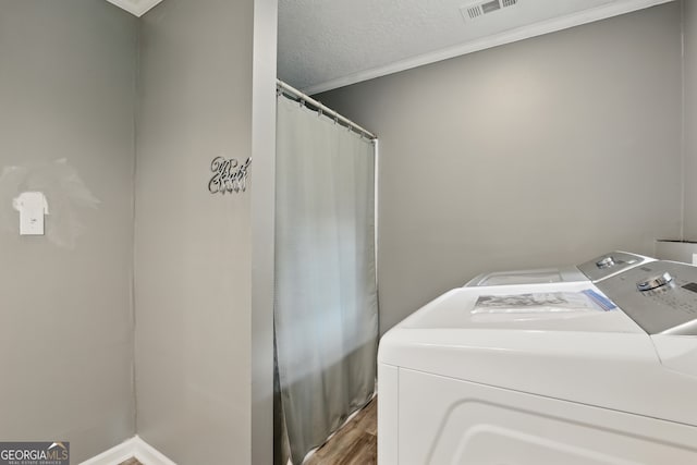 1469 Tabernacle Church Rd, Lincolnton, GA 30817 - laundry room featuring washer and dryer, crown molding, wood finished floors, and a textured ceiling