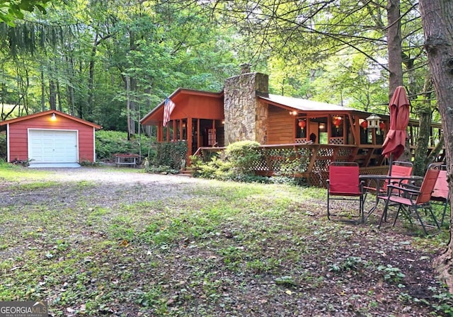 780 Watson Gap Rd, Mineral Bluff, GA 30559 - view of yard with an outdoor structure, a garage, driveway, and a forest view