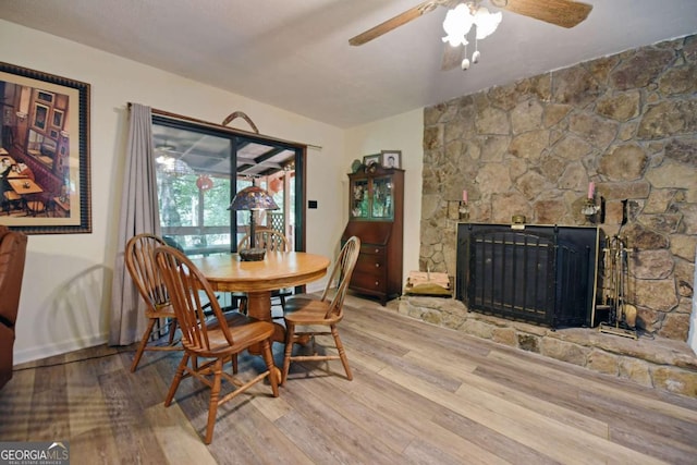 780 Watson Gap Rd, Mineral Bluff, GA 30559 - dining room with wood finished floors, ceiling fan, and a fireplace