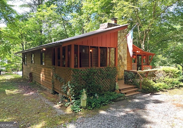 780 Watson Gap Rd, Mineral Bluff, GA 30559 - view of front of property with a chimney, stone siding, a sunroom, and board and batten siding