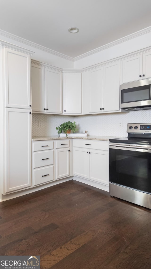 996 Palmetto Ave SW, Atlanta, GA 30314 - kitchen featuring appliances with stainless steel finishes, crown molding, dark wood-style flooring, light countertops, and backsplash