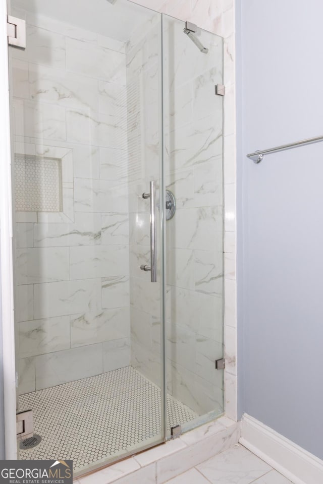 996 Palmetto Ave SW, Atlanta, GA 30314 - bathroom with marble look tile flooring and a stall shower