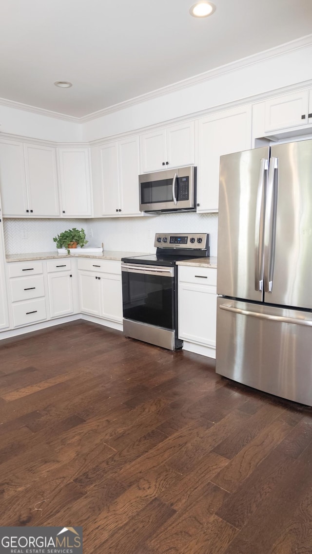 996 Palmetto Ave SW, Atlanta, GA 30314 - kitchen with appliances with stainless steel finishes, white cabinetry, crown molding, dark wood-type flooring, and recessed lighting