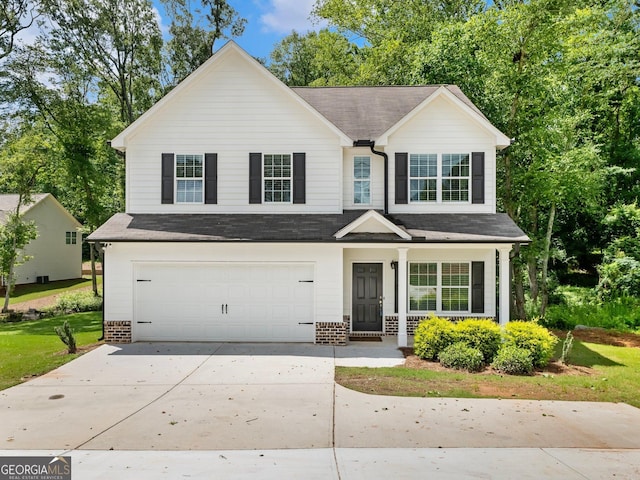 9701 Davis St, Braselton, GA 30517 - traditional home with brick siding, an attached garage, driveway, a porch, and a shingled roof