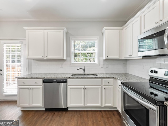 9701 Davis St, Braselton, GA 30517 - kitchen with appliances with stainless steel finishes, dark wood-style floors, white cabinetry, backsplash, and healthy amount of natural light