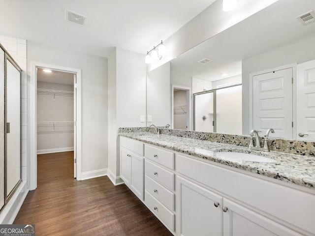 9701 Davis St, Braselton, GA 30517 - full bath with a walk in closet, a stall shower, double vanity, and wood finished floors