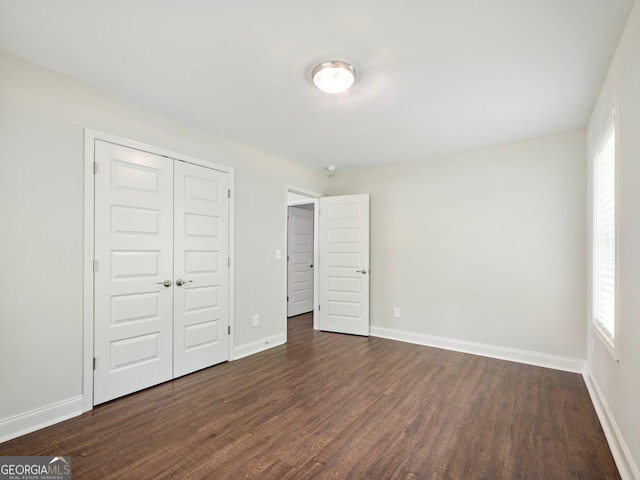 9701 Davis St, Braselton, GA 30517 - unfurnished bedroom featuring dark wood-type flooring and a closet