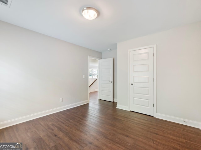 9701 Davis St, Braselton, GA 30517 - unfurnished bedroom featuring dark wood finished floors and baseboards