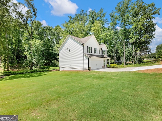9701 Davis St, Braselton, GA 30517 - view of side of property featuring an attached garage, a lawn, driveway, and view of wooded area