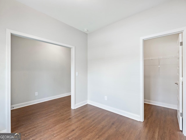 9701 Davis St, Braselton, GA 30517 - unfurnished bedroom with a walk in closet, wood finished floors, and a closet