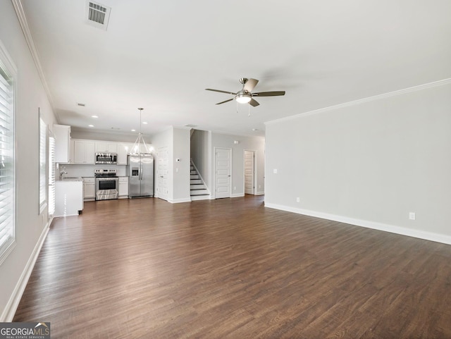 9701 Davis St, Braselton, GA 30517 - unfurnished living room featuring ceiling fan, plenty of natural light, stairs, dark wood-style flooring, and ornamental molding