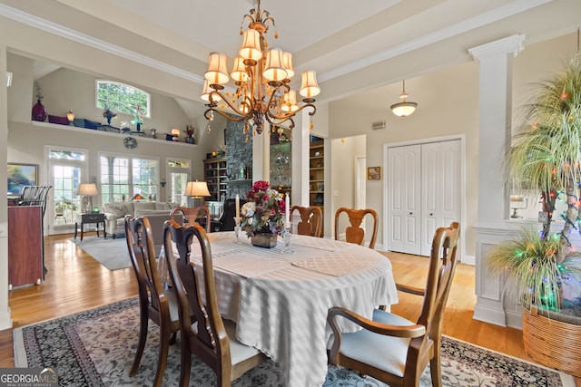 281 Hightower Lake Trl, Ball Ground, GA 30107 - dining area featuring a high ceiling, light wood-style flooring, a chandelier, and crown molding