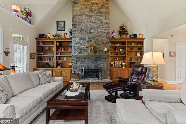281 Hightower Lake Trl, Ball Ground, GA 30107 - living room with wood finished floors, a fireplace, and high vaulted ceiling