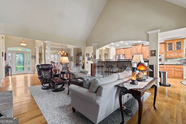 281 Hightower Lake Trl, Ball Ground, GA 30107 - living area with high vaulted ceiling, decorative columns, light wood-style flooring, arched walkways, and recessed lighting