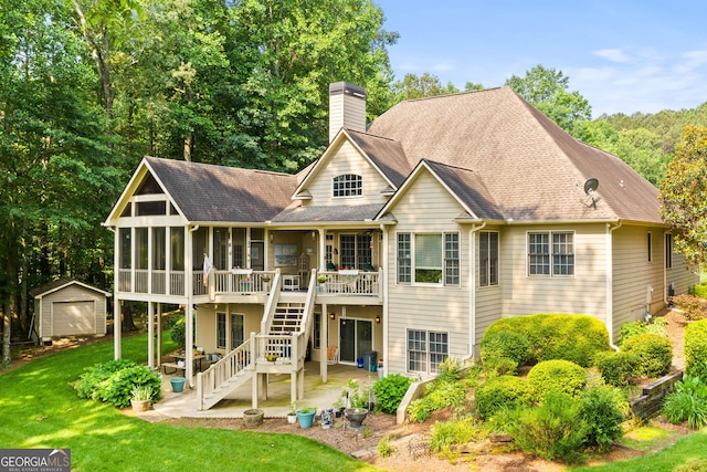 281 Hightower Lake Trl, Ball Ground, GA 30107 - rear view of house with a patio, a chimney, an outbuilding, a lawn, and a wooden deck
