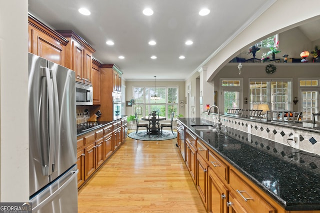 281 Hightower Lake Trl, Ball Ground, GA 30107 - kitchen featuring stainless steel appliances, brown cabinets, light wood-style floors, crown molding, and recessed lighting