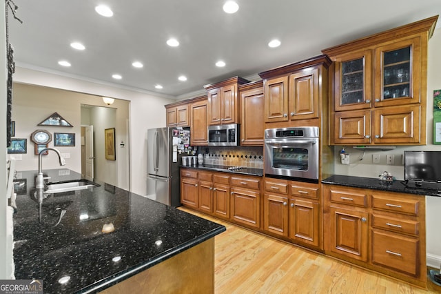 281 Hightower Lake Trl, Ball Ground, GA 30107 - kitchen featuring stainless steel appliances, crown molding, brown cabinetry, light wood finished floors, and decorative backsplash