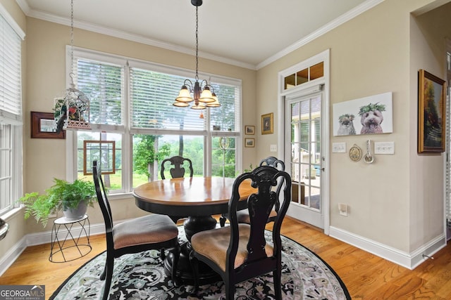 281 Hightower Lake Trl, Ball Ground, GA 30107 - dining space featuring ornamental molding, plenty of natural light, light wood finished floors, and a chandelier